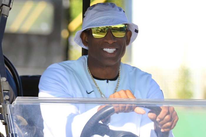 Deion Sanders on a golf cart at CU Fall Camp